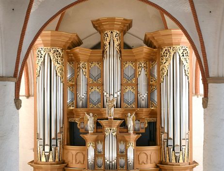 Eine prächtige Orgel mit goldenen Verzierungen und Pfeifen in einer Kirche.